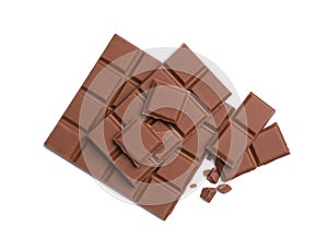 Pieces of delicious milk chocolate bars on white background, top view