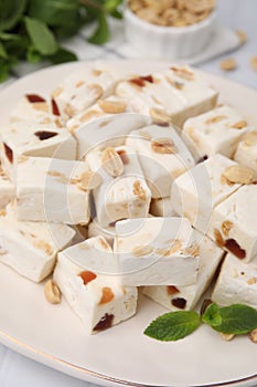 Pieces of delicious nutty nougat on plate