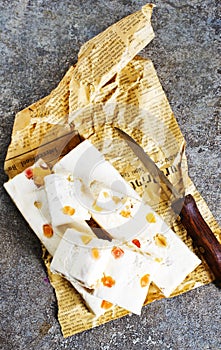 Pieces of delicious nutty nougat on table