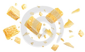 Pieces of delicious parmesan cheese flying on white background