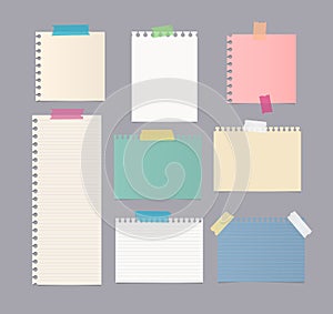 Pieces of different size colorful note, notebook, copybook paper sheets stuck with sticky tape on gray background