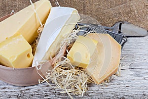 Different varieties of cheese on the old wooden surface