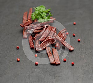 Pieces of dried meat and a branch of parsley and pepper peas