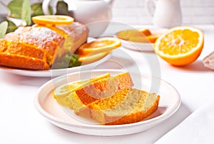 Pieces of fresh homemade baked sliced lemon cake on the white plate