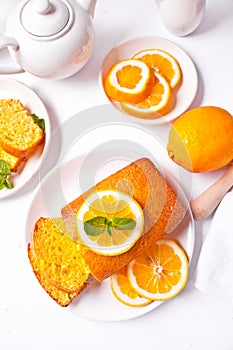 Pieces of fresh homemade baked sliced lemon cake on the white plate