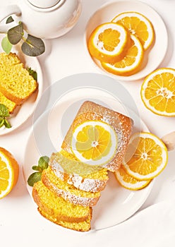 Pieces of fresh homemade baked sliced lemon cake on the white plate