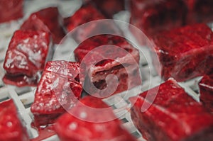 Pieces of fresh meat in the tray of an electric dryer to dehydrate food. Drying of food. Selective focus