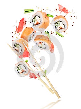 Pieces of fresh sushi with chopsticks frozen in the air