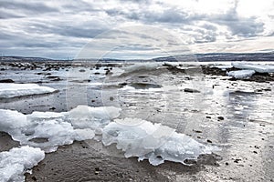 Pieces of freshwater ice at in the water near coast