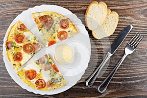 Pieces of fried eggs with sausage, tomatoes and greens, mayonnaise