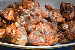 Pieces of fried meat are on a plate.