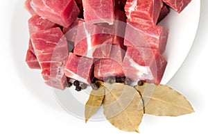 Pieces of frozen meat with laurel leaves isolated