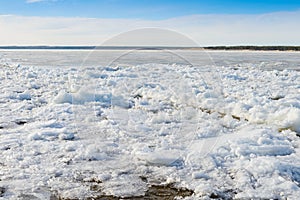 Pieces of ice float on river during the ice drift