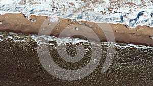 Pieces of ice float on waves, Ice plaques, sandy coast, stones, spring landscape, sunny weather