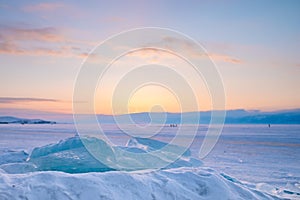 Pieces of Ice on frozen lake covering with snow.