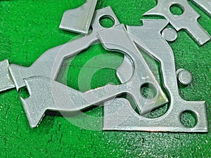 Pieces of iron on a green floor