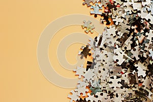 Pieces of jigsaw puzzle on beige color background