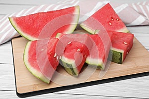 Pieces of juicy ripe watermelon on white table, closeup