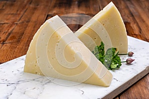 Pieces of matured pecorino romano italian cheese made from sheep milk in Lazio, Sardinia or Tuscany