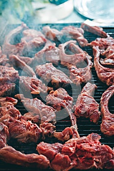 Pieces of meat grilling on a barbecue