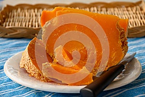Pieces of native French aged cheese Mimolette, produced in Lille with greyish curst made by special cheese mites close up