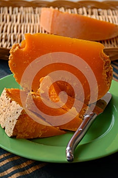 Pieces of native French aged cheese Mimolette, produced in Lille with greyish curst made by special cheese mites close up