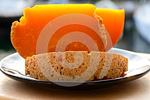Pieces of native French aged cheese Mimolette, produced in Lille with greyish curst made by special cheese mites close up