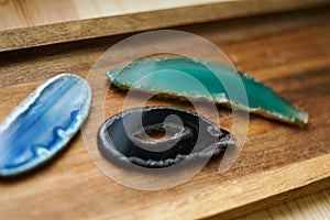 Pieces of natural agates on the wooden background.