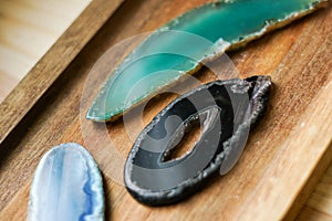 Pieces of natural agates on the wooden background.