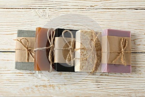 Pieces of natural handmade soap on wooden background