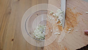 Pieces of onions lay out on the glass bowl close-up