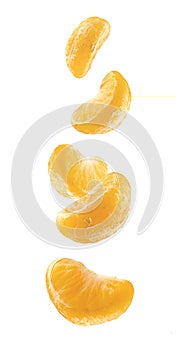 Pieces of peeled mandarin in the air isolated on a white background. Mandarin segments isolated. Five peeled falling