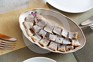 Pieces of pickled herring on a plate