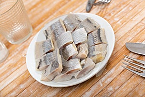 Pieces of pickled herring on a plate