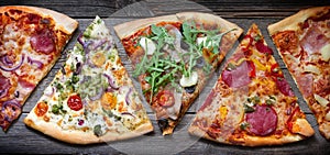 Pieces of pizza of different various types banner on old retro boards still life concept