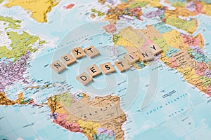 Pieces of a puzzle forming the word next destiny on a world map. Adventure travel concept