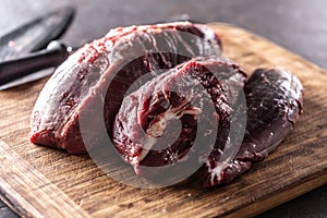 Pieces of raw beef shank placed on a wooden cutting board