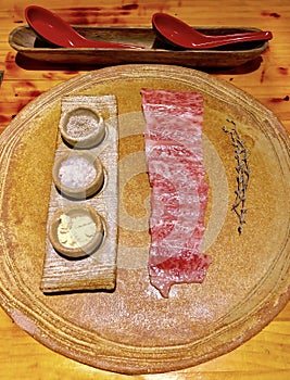 Pieces of raw marbled beef with various seasonings
