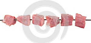 Pieces of raw meat on a skewer