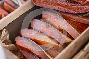 Pieces of red smoked fish on the counter. A popular delicacy of northern cuisine. Close-up