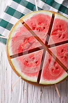 Pieces of ripe watermelon on a stick close-up. vertical top view