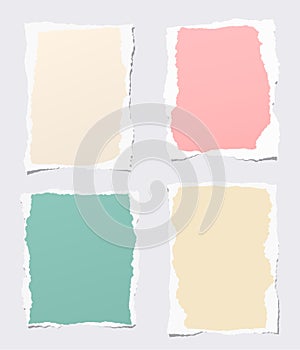 Pieces of ripped colorful blank notebook paper stuck on gray background