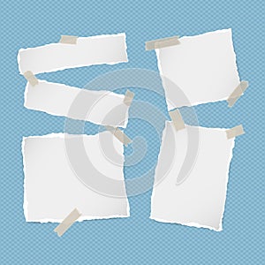 Pieces of ripped white note, notebook, copybook paper strips stuck with sticky tape on squared blue background.