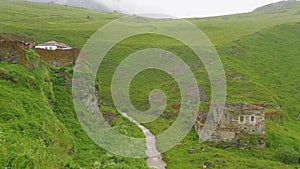 Pieces of ruined ancient mansory near mountain river