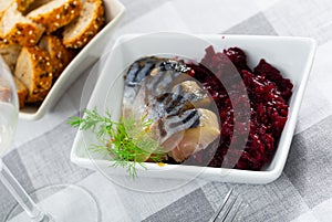 Pieces of scomber with beetroot served on plate