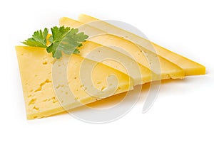 Pieces of semi-hard or hard yellow cheese with holes and parsley leaf isolated on a white background