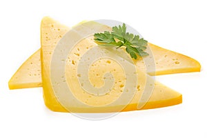 Pieces of semi-hard or hard yellow cheese with holes and parsley leaf isolated on a white background