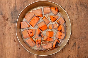 Pieces of sweet pumpkin baked with sugar for Halloween dinner. Healthy Vegetarian food. Autumn warm dish as a dessert. Selective