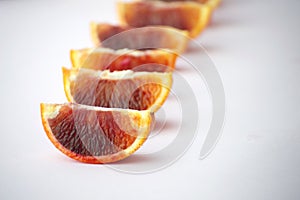 pieces of tasty juicy blood orange on white background. Horisontal. Healthy, seasonal concept.