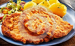 Pieces of Wiener schnitzel with potatoes photo